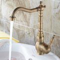 Close-up of InArt antique brass kitchen mixer tap lever handle and spout, single hole brass sink mixer detail