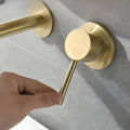 Close-up of brushed golden finish on brass wall mounted basin mixer, premium modern bathroom tapware