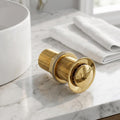 Gold finish pop-up waste coupling for wash basin with half cap top view