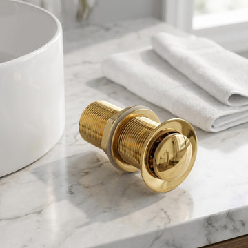Gold finish pop-up waste coupling for wash basin with half cap top view