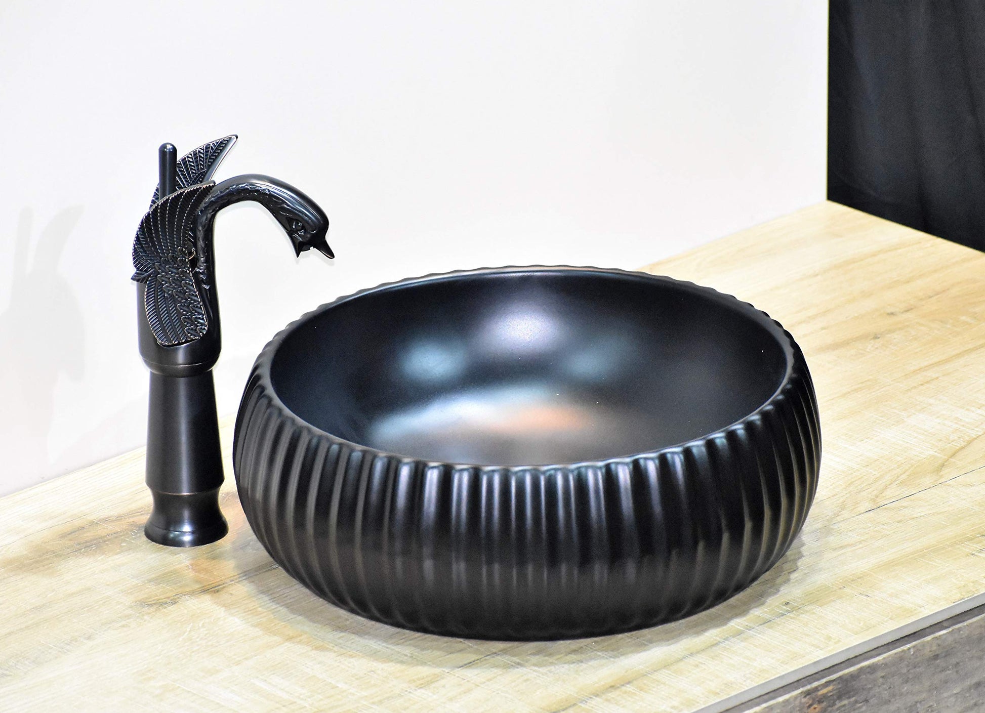 InArt designer matte black round ceramic table top wash basin, modern bathroom sink side angle view