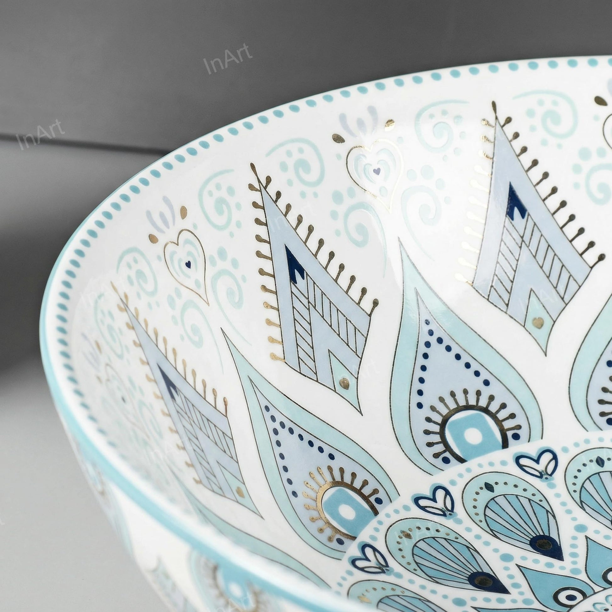 InArt table top wash basin counter design, round ceramic basin in light blue glossy finish on counter
