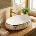 Close-up of golden rim on glossy white ceramic designer wash basin, premium finish detail