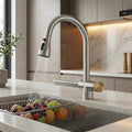 Close-up of InArt kitchen sink tap with pull out spray, waterfall outlet and smooth chrome brass body detailing