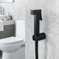 InArt black health faucet with hose and holder, close-up of brass build and premium matte finish