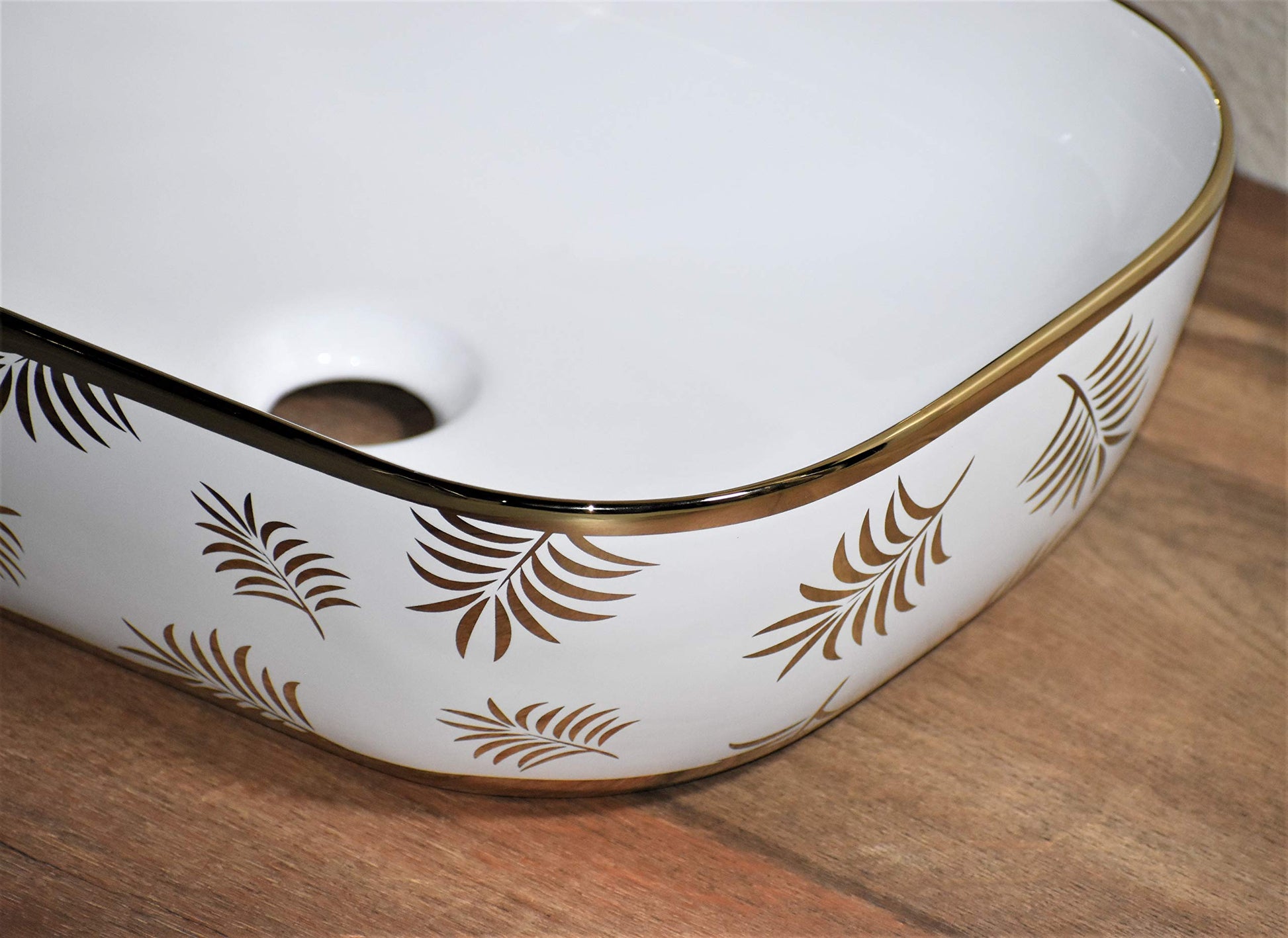 Close-up of glossy golden ceramic countertop sink rim, premium sanitaryware finish for luxury bathroom