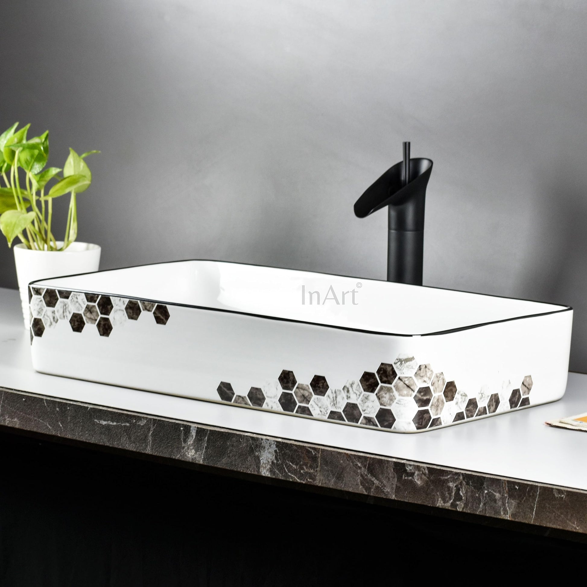 Designer table top wash basin design in black white ceramic, rectangular basin, top corner angle