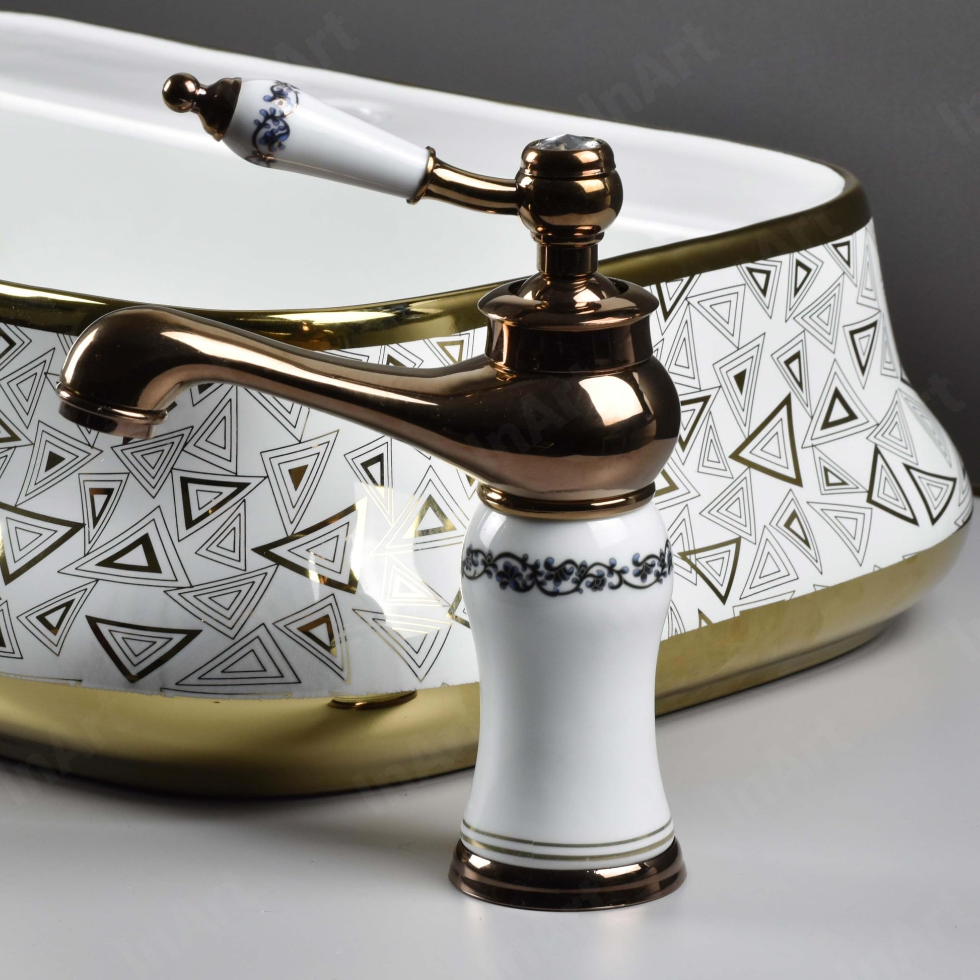 Close-up of InArt single lever wash basin mixer handle and glossy rose gold plating, contemporary design