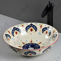 Round ceramic basin table top design by InArt, artistic beige blue finish, side angle in bathroom