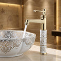 InArt single lever basin tap in golden finish, close-up of brass spout and lever for hot and cold water