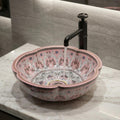 Ceramic wash basin design close-up showing smooth glossy pink glaze and oval rim detailing