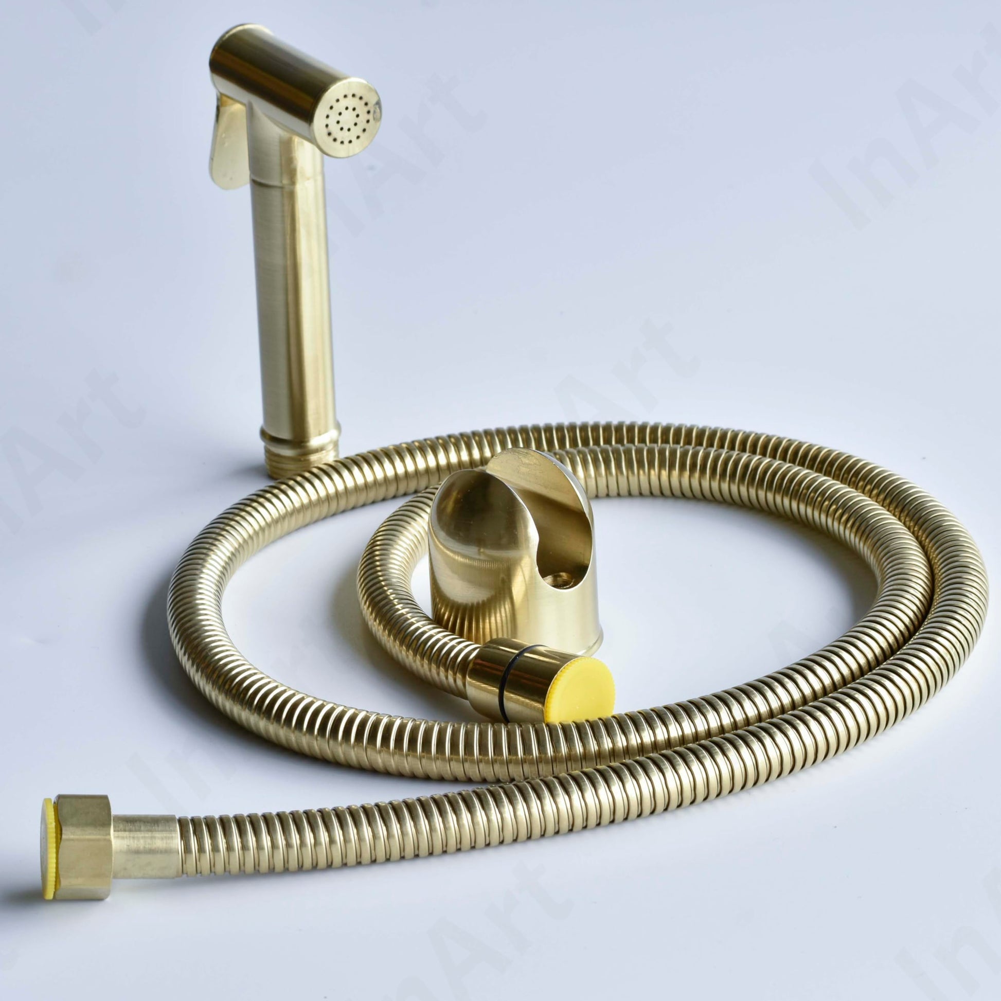 Golden health faucet set with hose and wall holder, angled view for modern bathroom washroom
