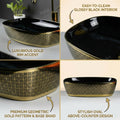 Modern bathroom table top wash basin design, oval ceramic glossy black gold, top angle showing rim