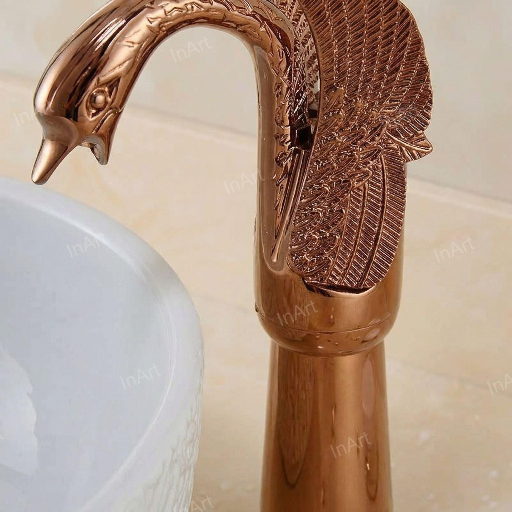 Close-up of single lever basin tap handle and rose gold finish on brass swan neck basin mixer