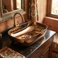 Close-up of InArt rose gold ceramic wash basin on table, smooth glazed rim and rectangular bowl detail