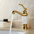 Single lever wash basin mixer single lever in gold finish with white handle, waterfall spout, side angle view