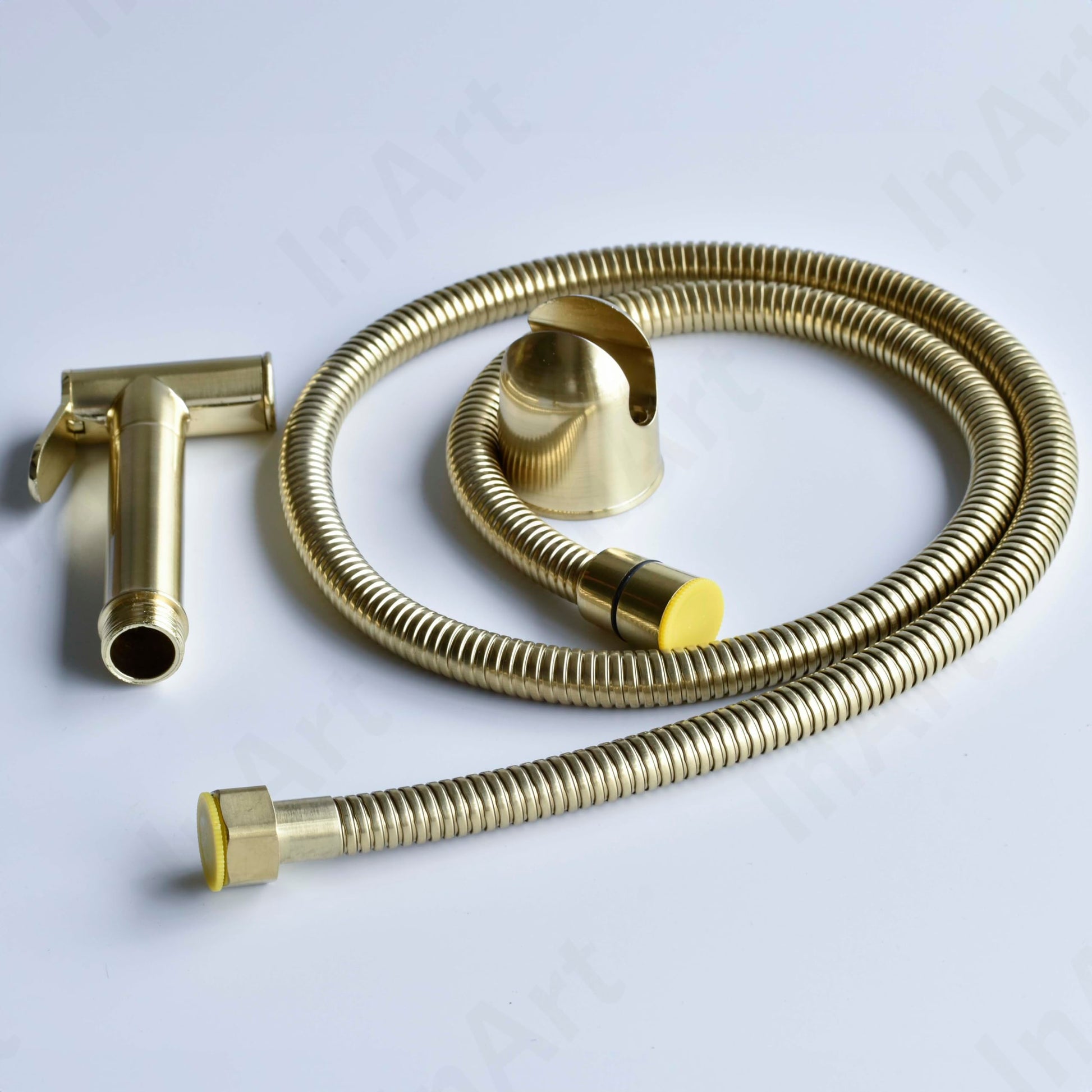 Close-up of InArt brass jet spray for low water pressure bathrooms, smooth golden finish detail