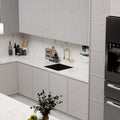 Close-up of 3 flow pull out mixer spray head on brushed gold kitchen sink mixer tap for rinse and stream modes