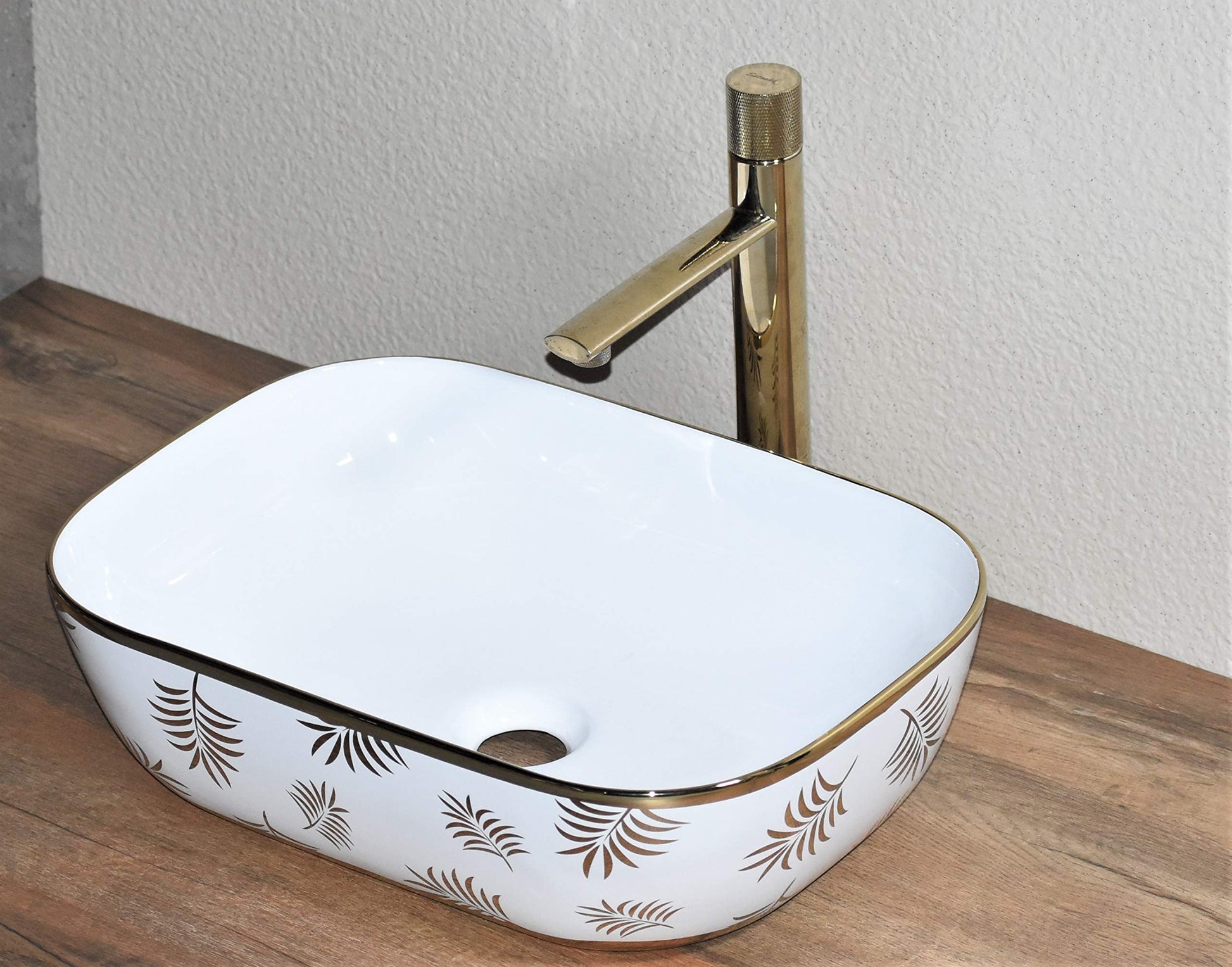 Modern table top wash basin design in glossy golden ceramic, side angle above counter wash basin