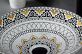 Modern table top wash basin design in glossy yellow Mexican pattern ceramic, side angle view
