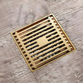 InArt designer floor drain jali in antique brass, side angle view of square grate and trap fit for 4 inch pipe