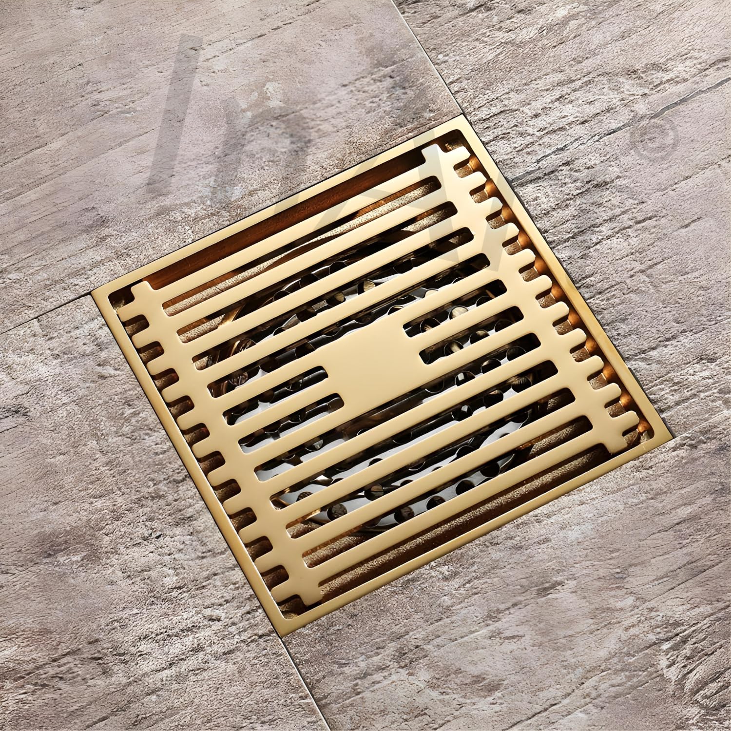 InArt designer floor drain jali in antique brass, side angle view of square grate and trap fit for 4 inch pipe