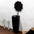Modern designer pedestal wash basin in glossy black ceramic, round single piece basin side angle view