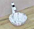 Square counter top wash basin design in white marble finish, angled view for modern bathroom