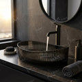Top view of oval black glass wash basin for counter installation