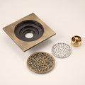 Close-up of antique finish square brass drain cover with tile insert design