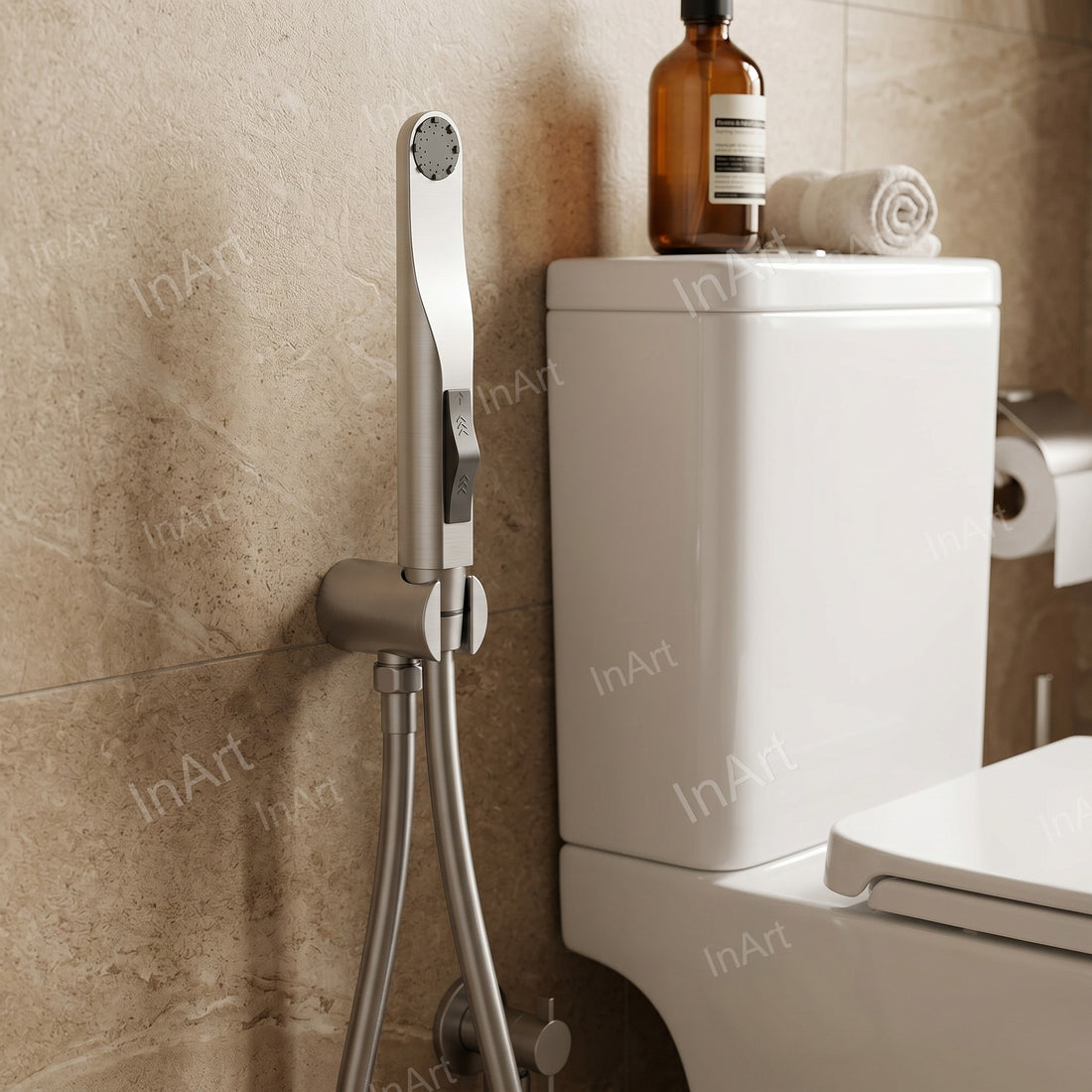 Close-up of brushed toilet spray gun handle and water outlet connection