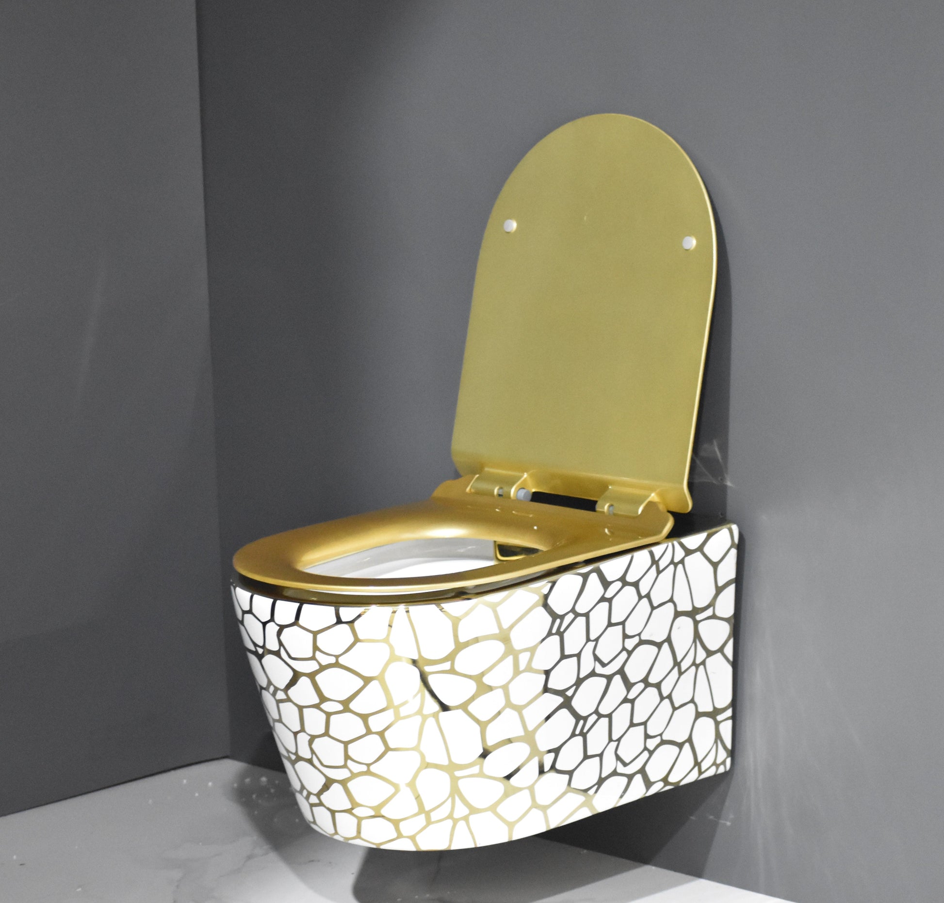 InArt ceramic gold wall hung toilet seat - close-up detail of mounting hardware and designer finish